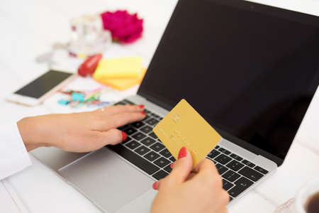 Woman with laptop computer and credit cardの写真素材