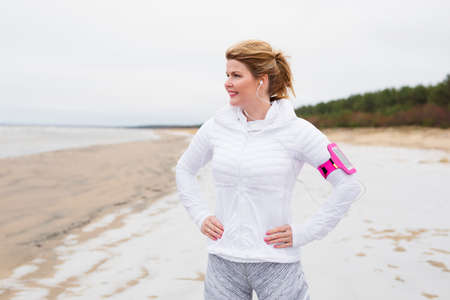 Fitness woman on th beach in winterの写真素材