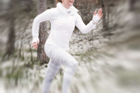 Motion blurred runner in winterの写真素材