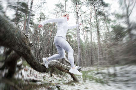 Motion blurred woman exercise outdoors in winterの写真素材