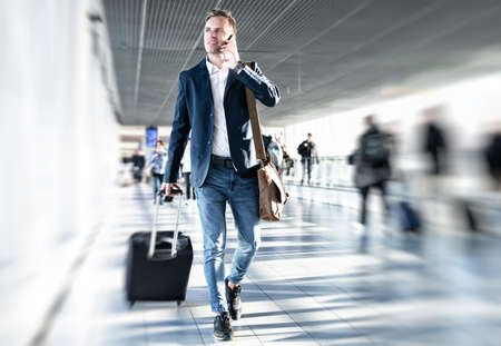Businessman walking in airportの写真素材