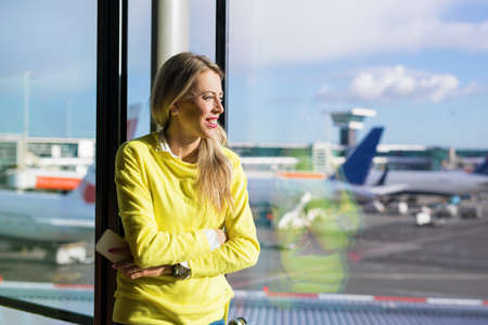 Woman waiting for her flight in airportの写真素材