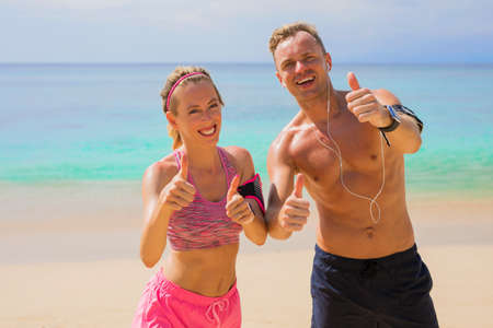 Happy fitness people on the beachの写真素材