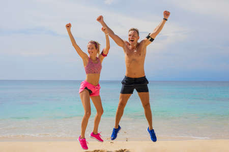 Excited people after workout on the beachの写真素材