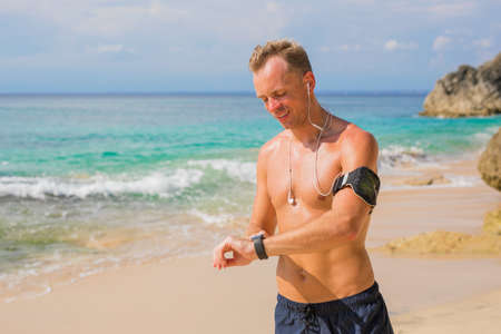 Man using fitness app on smartwatchの写真素材