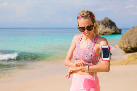 Woman using smartwatch during workoutの写真素材