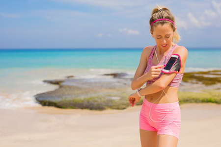 Woman using fitness tracking app on smartphoneの写真素材