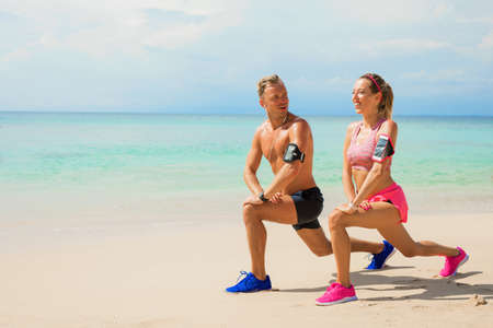 Friends exercise together on the beachの写真素材