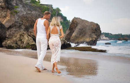 Romantic couple walking on the beachの写真素材