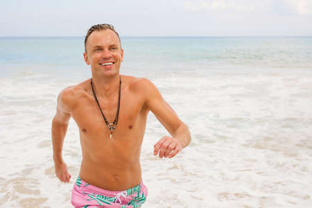 Man running out of water in oceanの写真素材