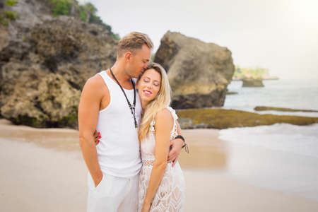 Romantic couple standing on the beachの写真素材