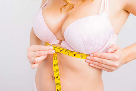 Woman measuring chest base size for perfect bra fitの写真素材