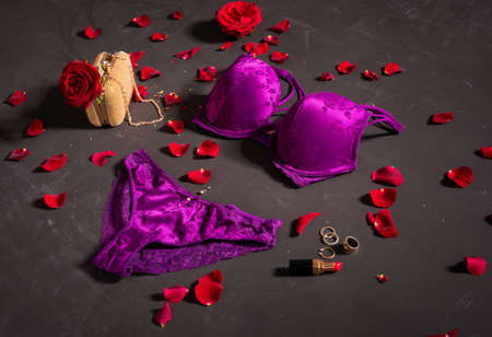 Sexy purple woman's underwear and accessories on dark floorの写真素材