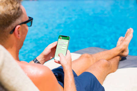 Man texting with his girlfriend on phoneの写真素材