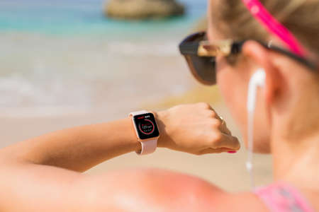 Woman looking at her heart rate data on smartwatchの写真素材
