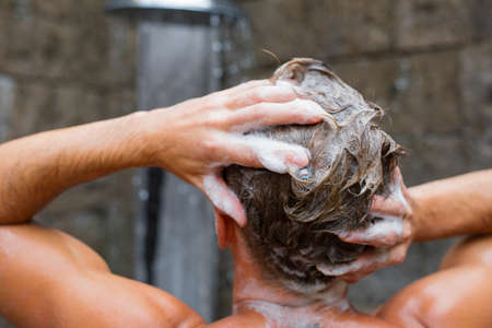 Man washing hair with shampooの写真素材