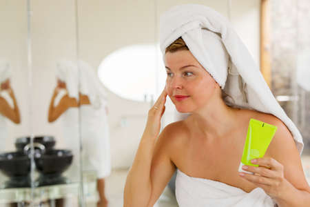 Woman using facial creamの写真素材