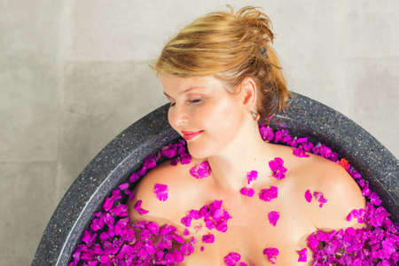 Portrait of woman in flower bathの写真素材
