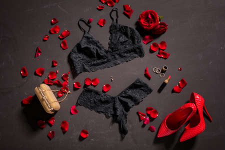 Women's black lace sexy lingerie and accessories on black surfaceの写真素材