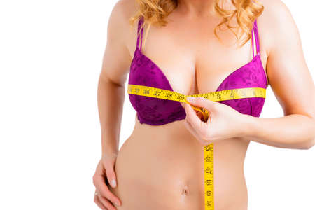 Woman measuring bust size with measurement tapeの写真素材
