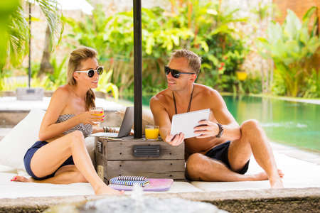 Young couple relaxing in luxury tropical villaの写真素材