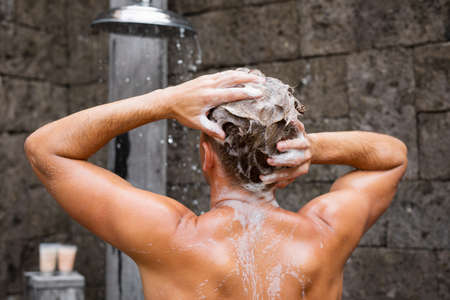 Man washing head with shampooの写真素材