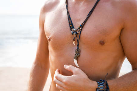 Shirtless man with necklacesの写真素材