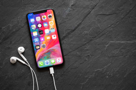 Riga, Latvia - March 25, 2018: Latest generation iPhone X with earphones.のeditorial素材