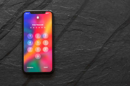 Riga, Latvia - March 25, 2018: Latest generation iPhone X with locked screen.のeditorial素材