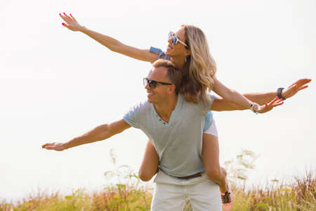 Couple piggybacking outdoorsの写真素材
