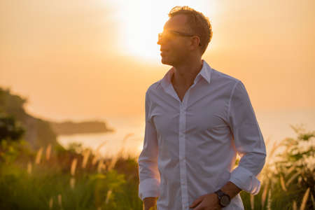 Handsome man at sunsetの写真素材