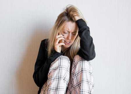 Very sad woman talking on phoneの写真素材