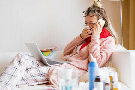 Sick woman working from homeの写真素材