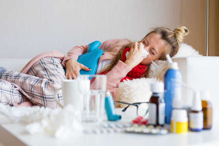Sick woman lying in bedの写真素材