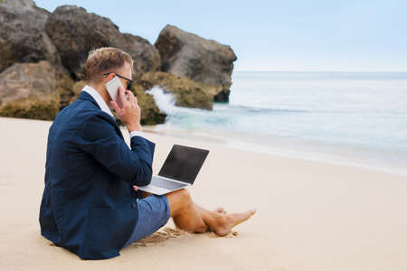 Busy man working on the beachの写真素材