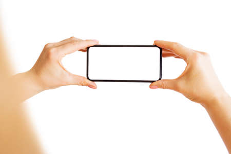 Person taking photo with phone. Isolated on white.の写真素材