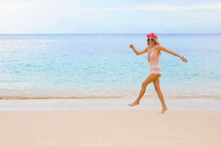 Happy woman walking by the oceanの写真素材