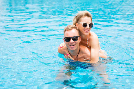 Couple having fun in the poolの写真素材