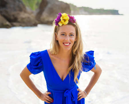 Happy natural woman in blue dress on the beachの写真素材