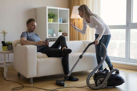 Young couple arguing about housekeeping issuesの写真素材