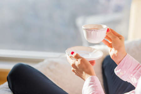 Woman holding cup of teaの写真素材