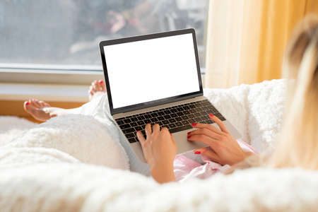 Woman working with laptop at homeの写真素材
