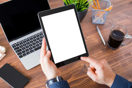 Business man working on tablet computer. Tablet vertical screen mockup.の写真素材