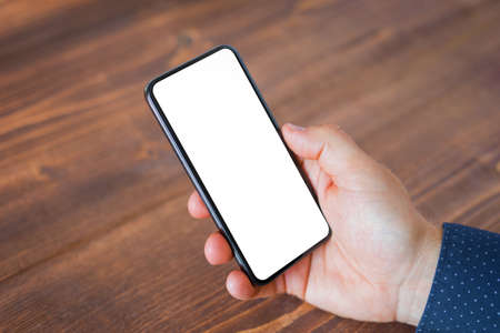 Business man using mobile phone with blank empty screen.の写真素材