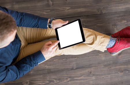 Man using digital tablet. Tablet vertical screen mockup.の写真素材