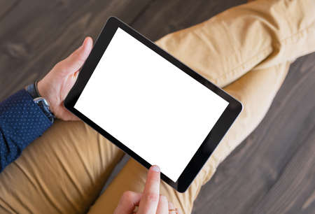 Man using digital tablet. Tablet horizontal screen mockup.の写真素材