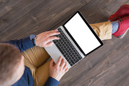 Man working on laptop computer. Laptop screen mockup.の写真素材