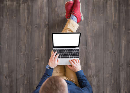 Man using laptop computer. Laptop screen mockup.の写真素材