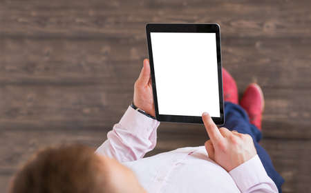 Man holding tablet. Tablet vertical screen mockup.の写真素材