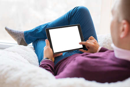 Man using tablet. Tablet horizontal screen mockup.の写真素材